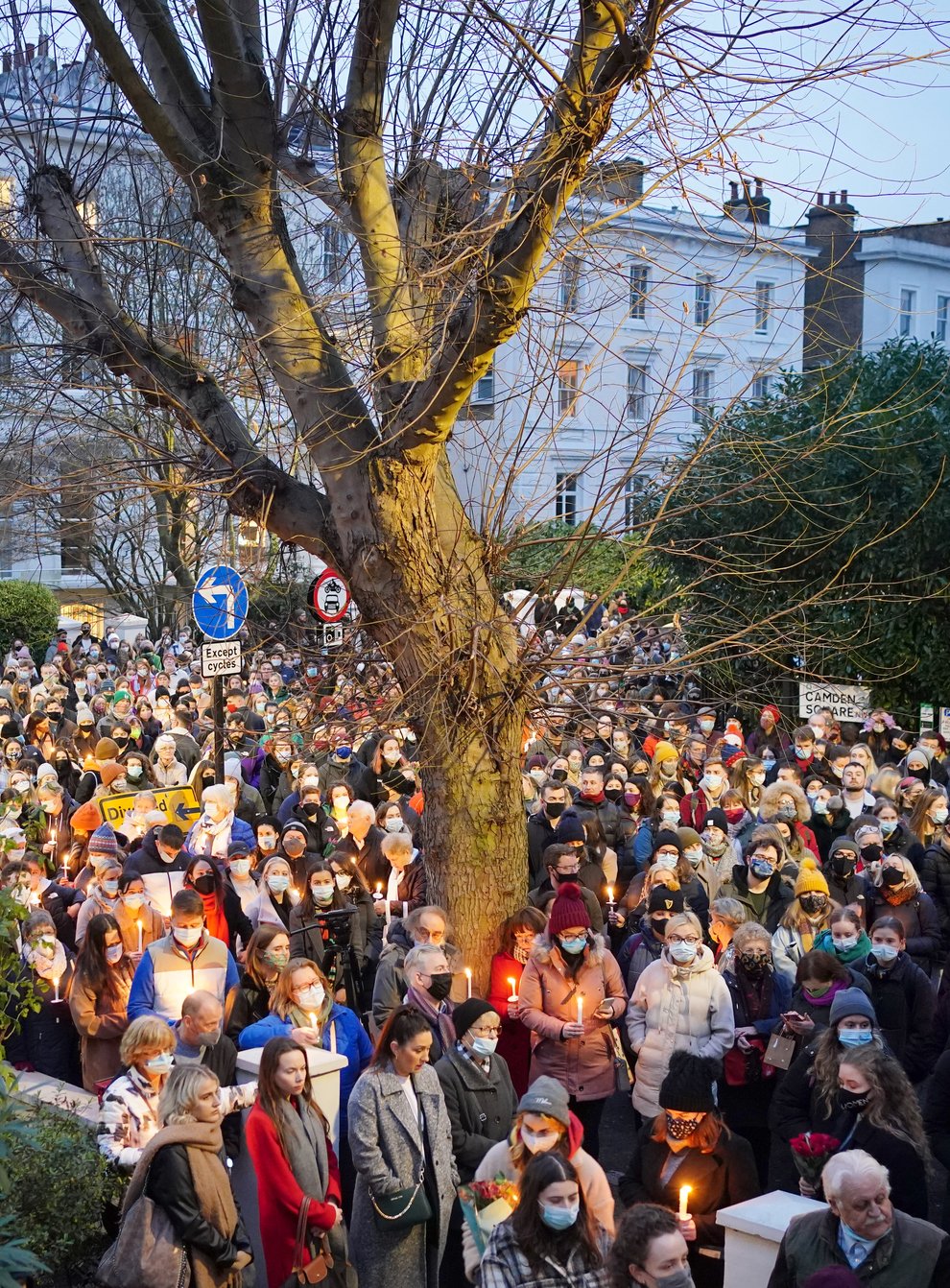 People hold a vigil outside the London Irish Centre in Camden (Dominic Lipinski/PA)