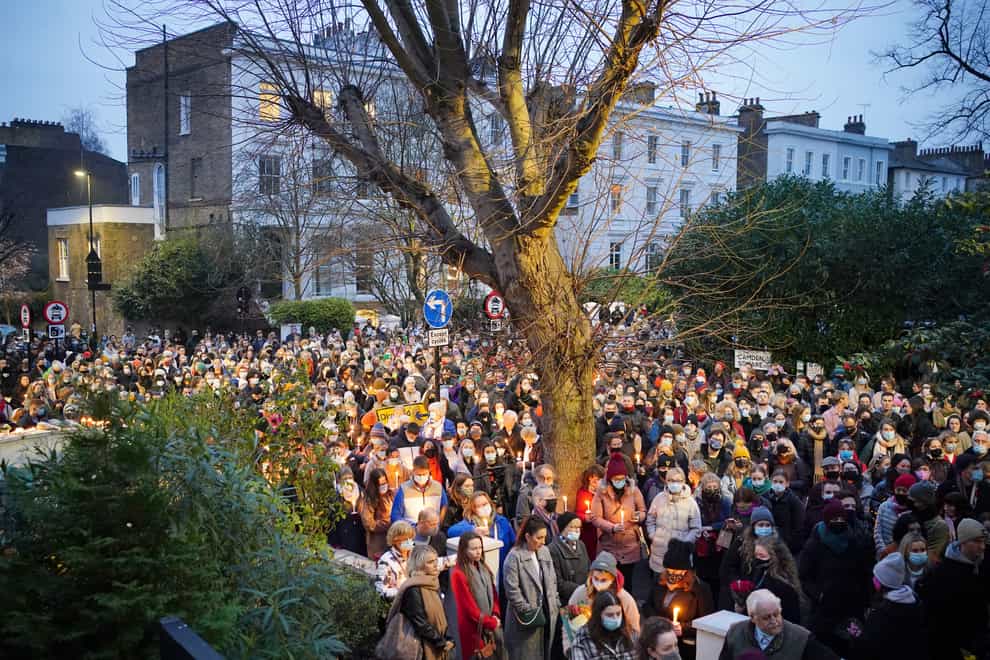 People hold a vigil outside the London Irish Centre in Camden (Dominic Lipinski/PA)