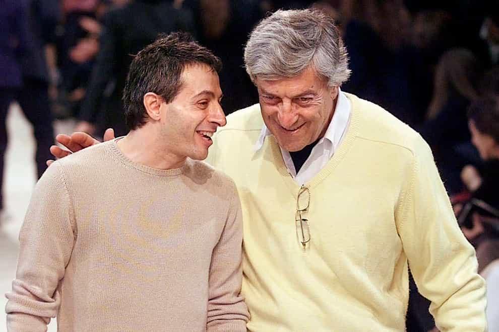 Designer Peter Speliopoulos, left, and Nino Cerruti talk on the catwalk in 2001 (Michel Euler/AP)