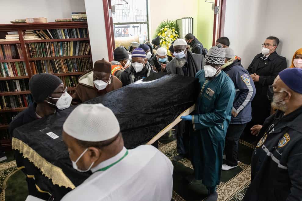 People bring in a casket during the funeral service for victims of the apartment building fire, at the Islamic Cultural Centre for the Bronx (Yuki Iwamura/AP)