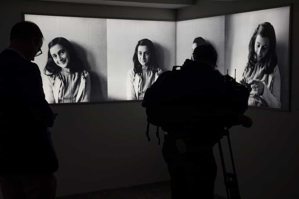A journalist takes images of pictures of Anne Frank at the renovated Anne Frank House Museum in Amsterdam, Netherlands (Peter Dejong/AP)