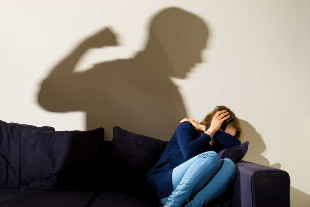 PICTURE POSED BY MODEL File photo dated 09/03/15 of a shadow of a man with a clenched fist as a woman cowers in the corner (Dominic Lipinski/PA)