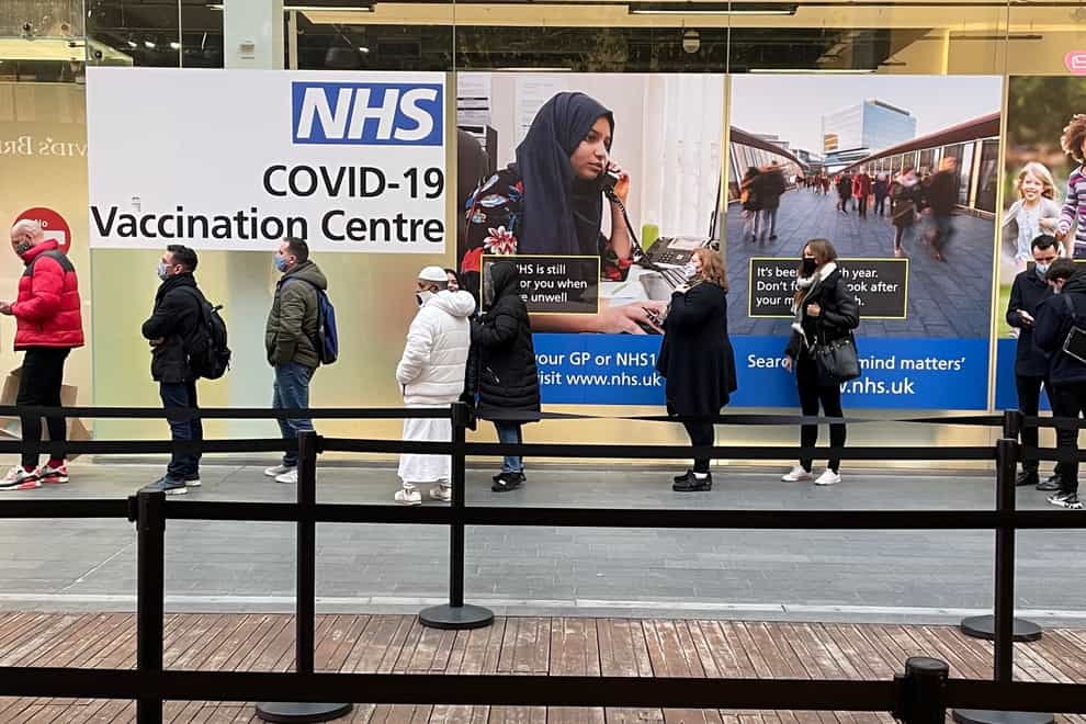 People queue at a Covid-19 vaccination centre at the Westfield shopping centre in Stratford, east London (Jonathan Brady/PA)