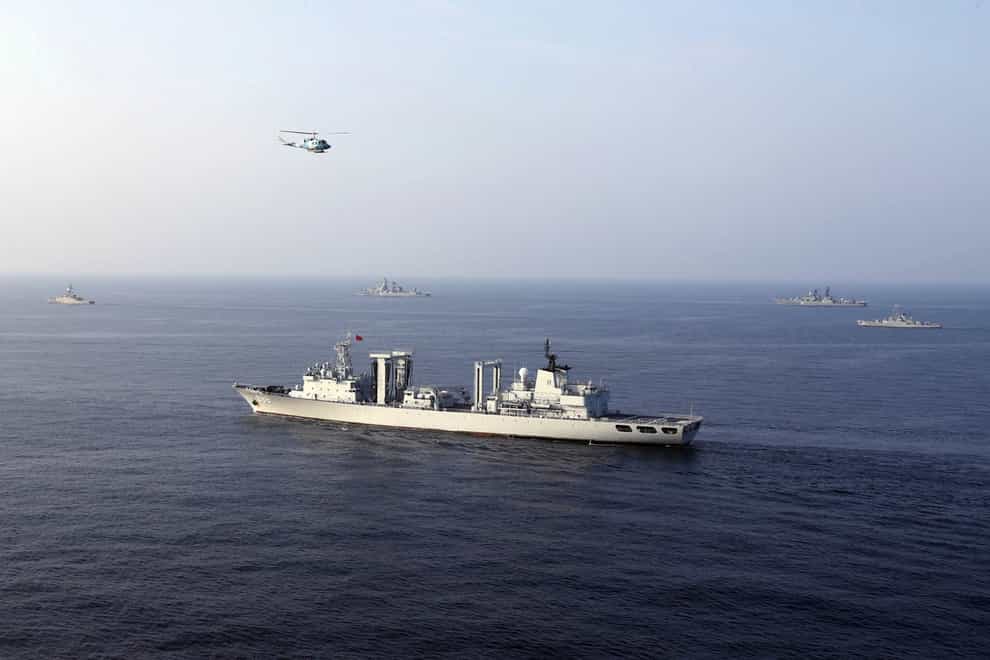 Warships and a helicopter attend a joint naval drill of Iran, Russia and China in the Indian Ocean (Iranian Army via AP)