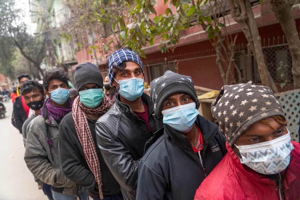 People queue to receive a Covid vaccine in Kathmandu, Nepal (Niranjan Shrestha/AP)
