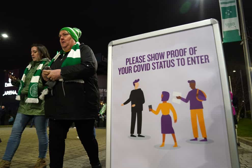 Celtic fans pass Covid-19 signs at the Premiership match at Celtic Park, Glasgow (Andrew Milligan/PA)