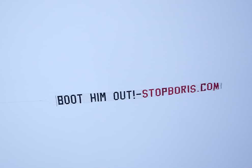 A sign protesting against Prime Minister Boris Johnson is flown over Manchester United’s Premier League match with West Ham at Old Trafford, Manchester (PA)