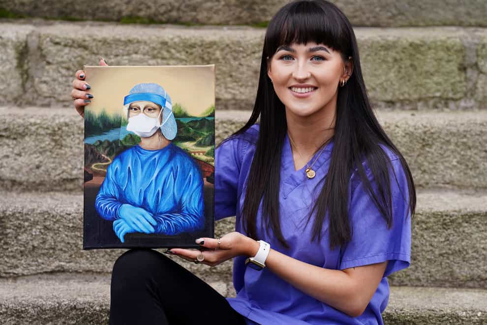 Trainee nurse Chloe Slevin with her painting Corona Lisa, which she is to auction for charity (Brian Lawless/PA)