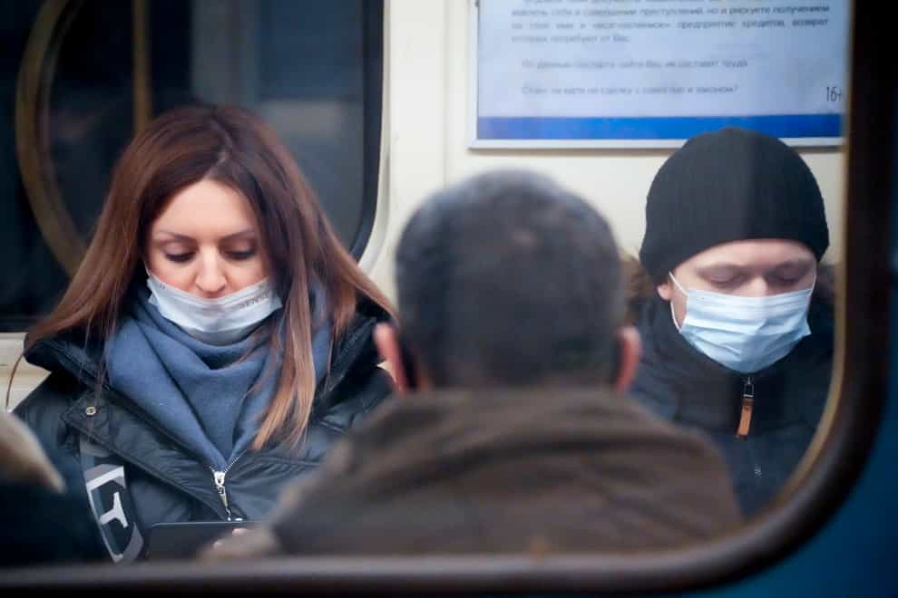 People wearing face masks to help protect against the spread of the coronavirus on the underground in St. Petersburg, Russia (Dmitri Lovetsky/AP)