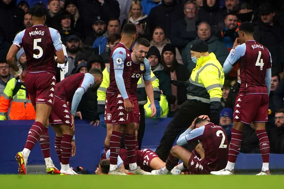 Aston Villa’s Lucas Digne and Matty Cash react to being hit by a missile (Peter Byrne/PA)