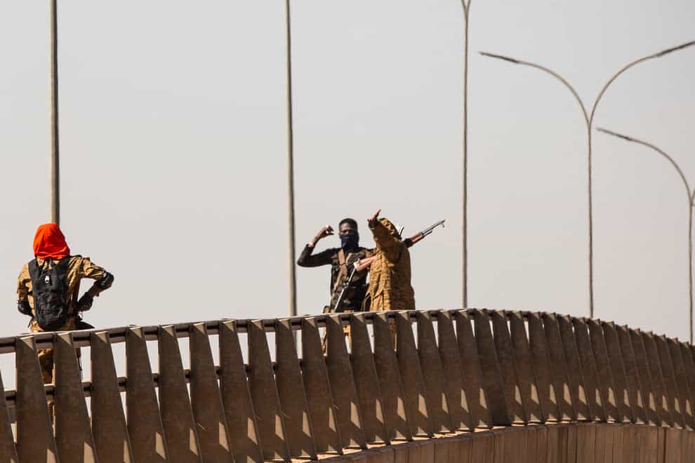Mutinous soldier stand on a bridge at the Bobo interchange near the Lamizana camp in Burkina Faso’s capital Ouagadougou (Sophie Garcia/AP)