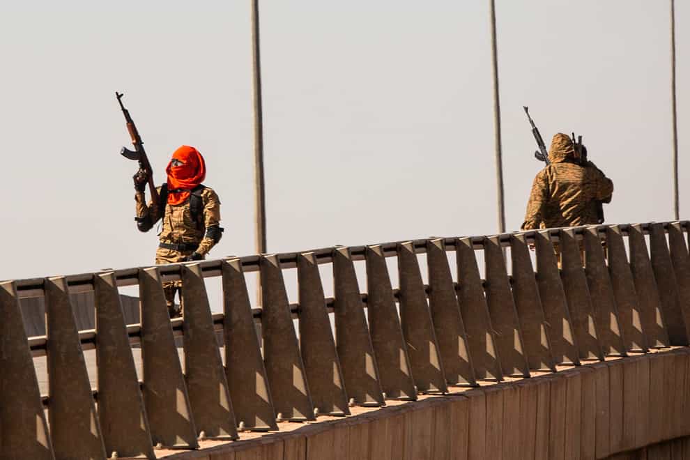 A mutinous soldier fires into the air at the Bobo interchange, near the Lamizana camp in Burkina Faso’s capital Ouagadougou (Sophie Garcia/AP)