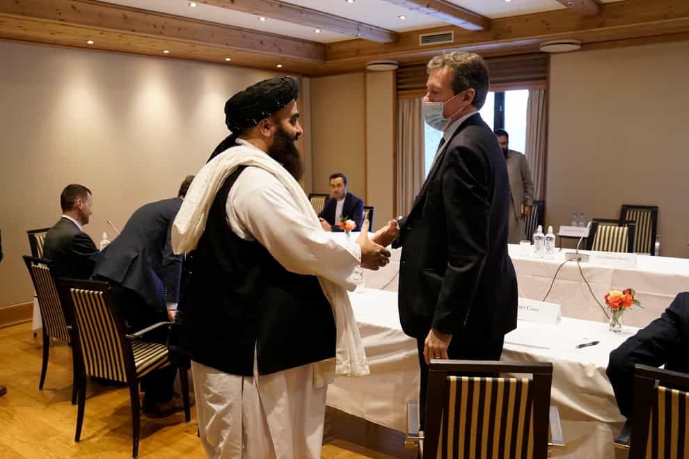 Special representative for Afghanistan Nigel Casey, right, shakes hands with Taliban representative Amir Khan Muttaqi, centre, ahead of a meeting in Oslo, Norway (Stian Lysberg Solum/NTB via AP)