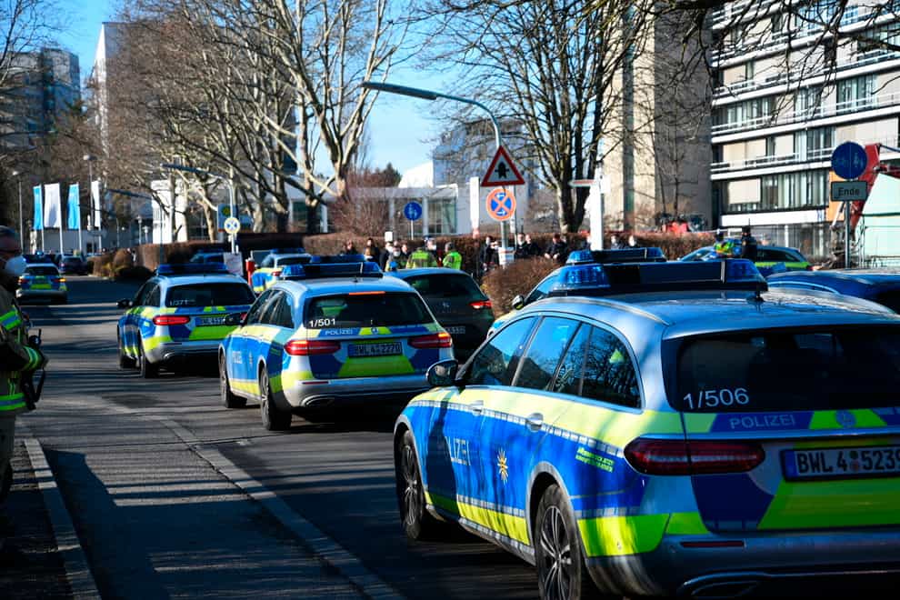 Police vehicles on the grounds of Heidelberg University in Germany (R.Priebe/Pr-Video/dpa via AP)