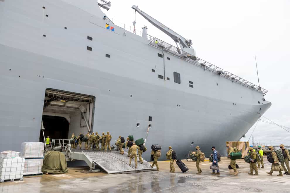 In this photo provided by the Australian Defence Force, soldiers load onto HMAS Adelaide at the Port of Brisbane (Cpl Robert Whitmore/Australia Defence Force via AP)