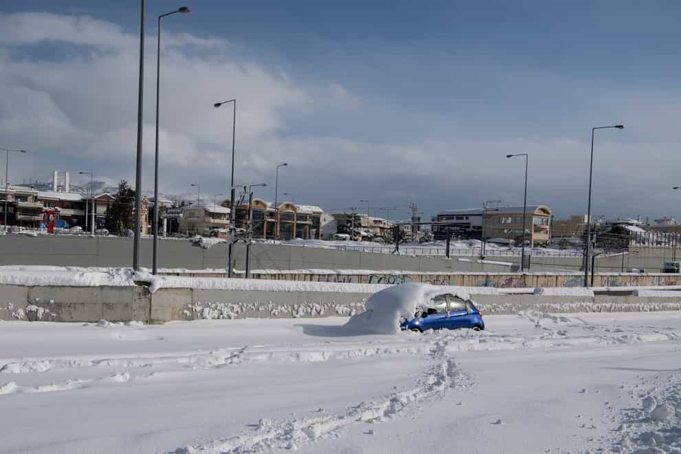 An abandoned vehicle, is seen in an motorway way after a snowstorm, in Athens, on Tuesday, Jan. 25, 2022. Army and fire service teams were deployed late Monday to extract hundreds of motorists trapped for hours in snowed-in cars. A snowstorm of rare severity disrupted road and air traffic Monday in the Greek capital of Athens and neighboring Turkey’s largest city of Istanbul, while most of Greece, including — unusually — several Aegean islands, and much of Turkey were blanketed by snow. (AP Photo/Michael Varaklas)