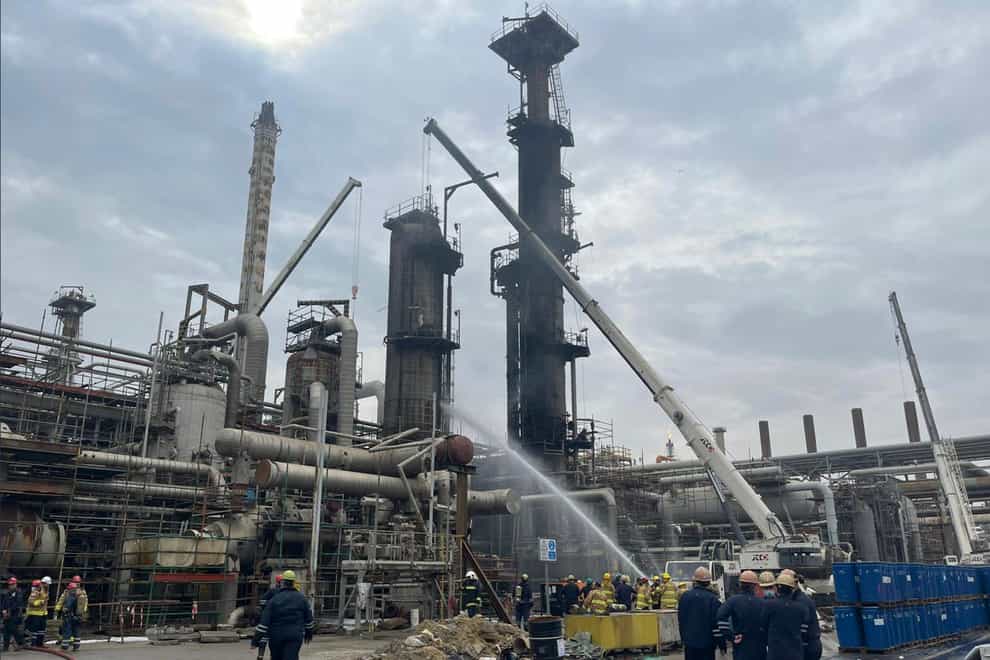 Firefighters try to extinguish the fire at the Mina al-Ahmadi oil refinery in Kuwait (AP)