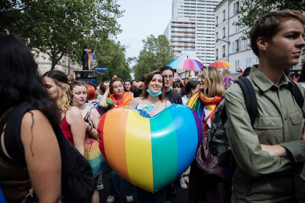 A participant holds a rainbow heart during the annual Gay Pride march in Paris last year (Lewis Joly/AP)