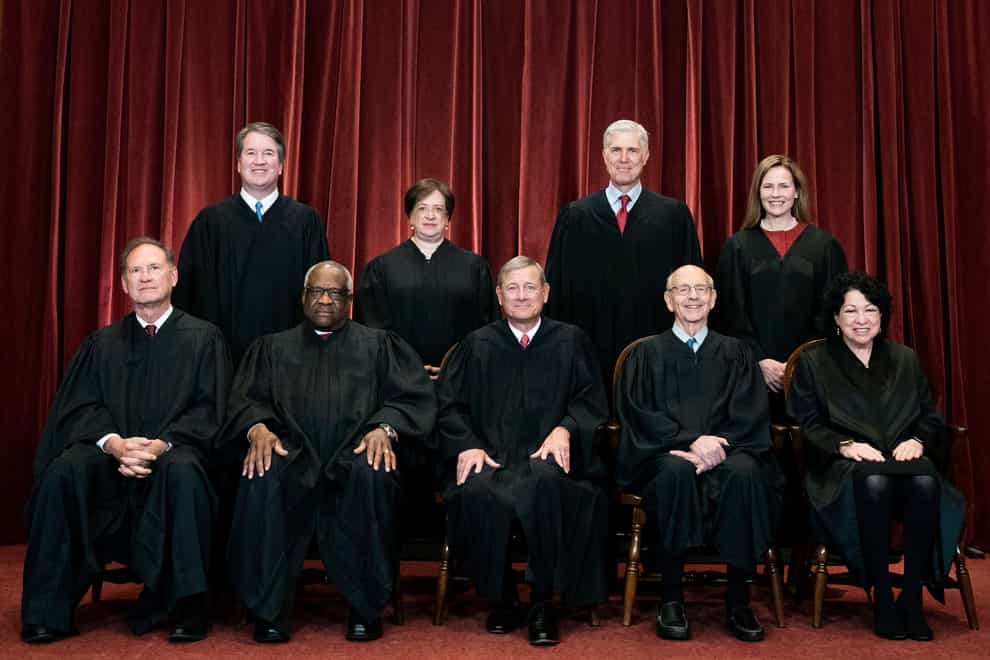 Members of the Supreme Court pose for a group photo at the Supreme Court in Washington (Erin Schaff/AP)