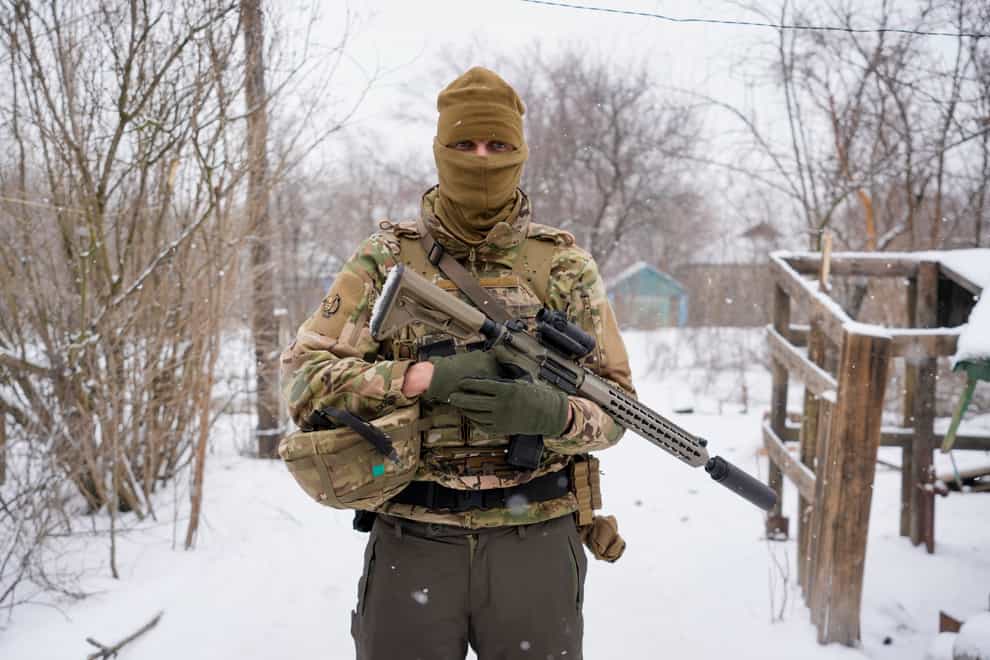 A Ukrainian sniper poses for a photo before moving to a position on the front line in the Luhansk region, eastern Ukraine, Friday, Jan. 28, 2022. High-stakes diplomacy continued on Friday in a bid to avert a war in Eastern Europe. The urgent efforts come as 100,000 Russian troops are massed near Ukraine’s border and the Biden administration worries that Russian President Vladimir Putin will mount some sort of invasion within weeks. (AP Photo/Vadim Ghirda)