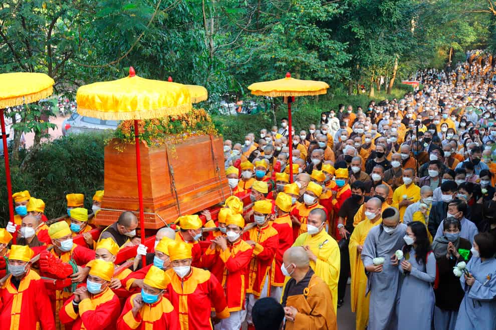 The coffin of Thich Nhat Hanh is carried through the street during his funeral in Hue, Vietnam, on Saturday (AP Photo/Thanh Vo).
