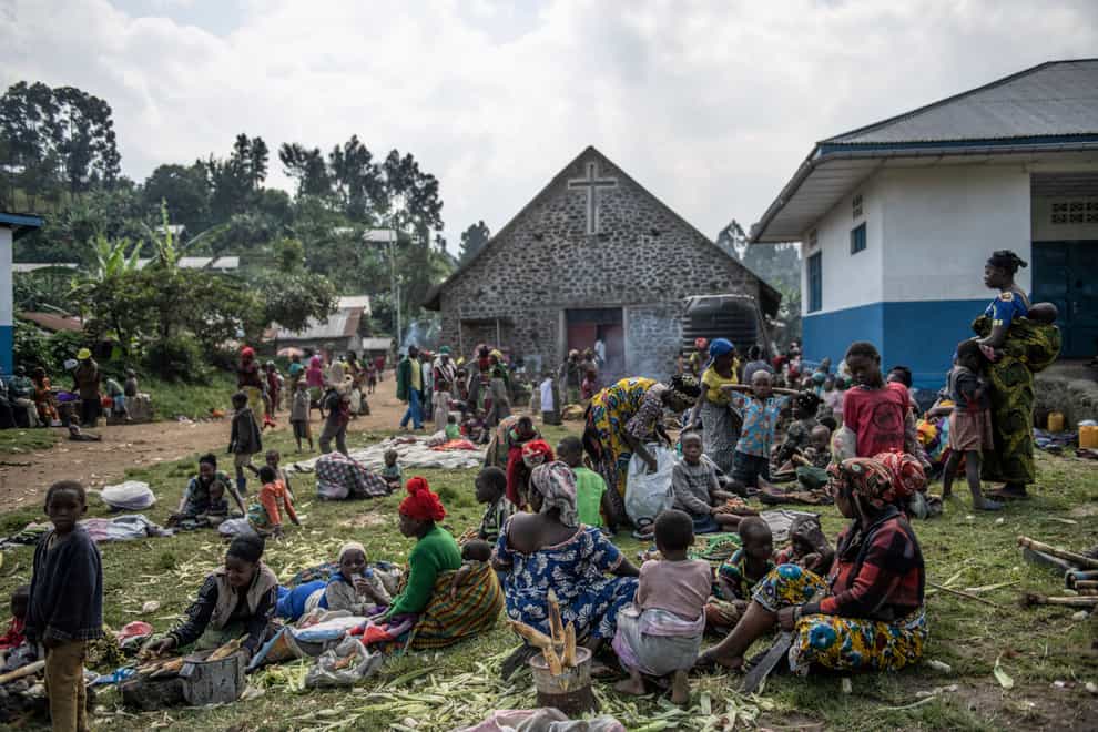 People fleeing the fighting between M23 forces and the Congolese army find refuge in a church in Kibumba, north of Goma (AP)