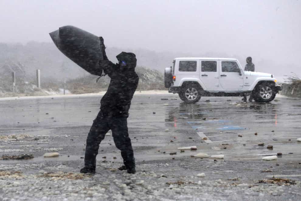 Heavy snow and high winds in West Barnstable, Massachusetts (Cape Cod Times via AP)