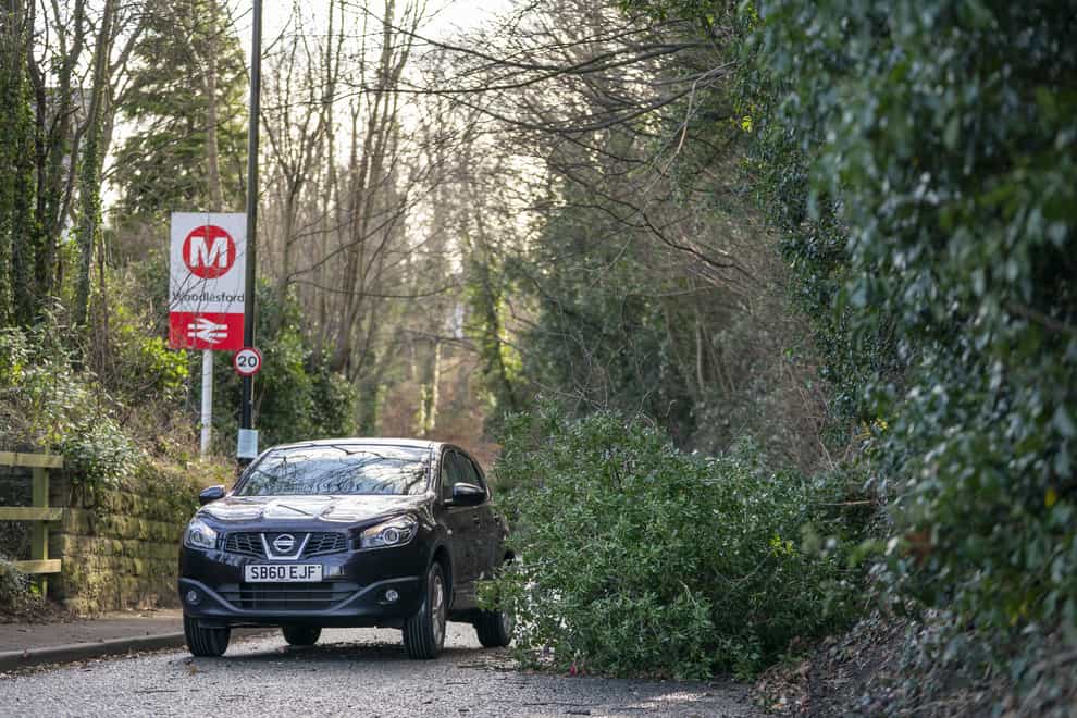 A fallen tree blocks a road in Woodlesford in West Yorkshire, as gusts of up to 80mph could batter northern areas of the UK this weekend as Storm Malik sweeps in (Danny Lawson/PA)