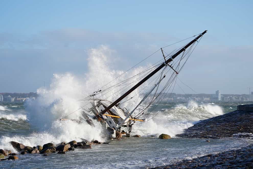 Waves crash against a boat in Elsinore, Denmark (Keld Navntoft/Ritzau Scanpix via AP)