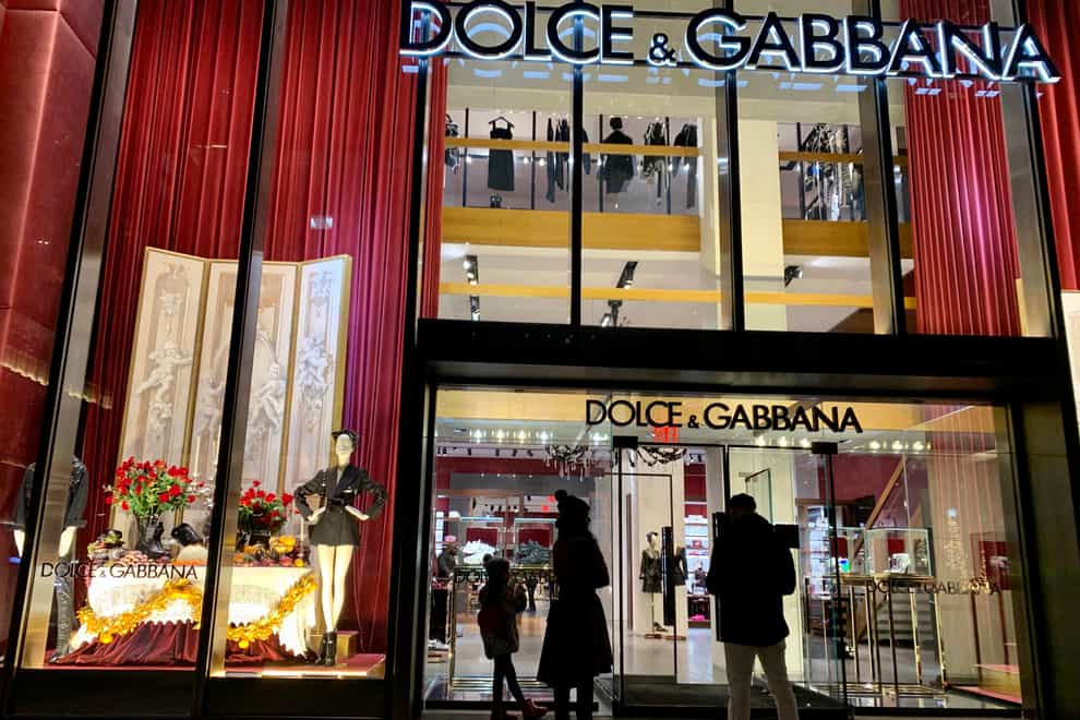 People stand outside the Dolce & Gabbana store on Fifth Avenue in New York (Pamela Hassell/AP)