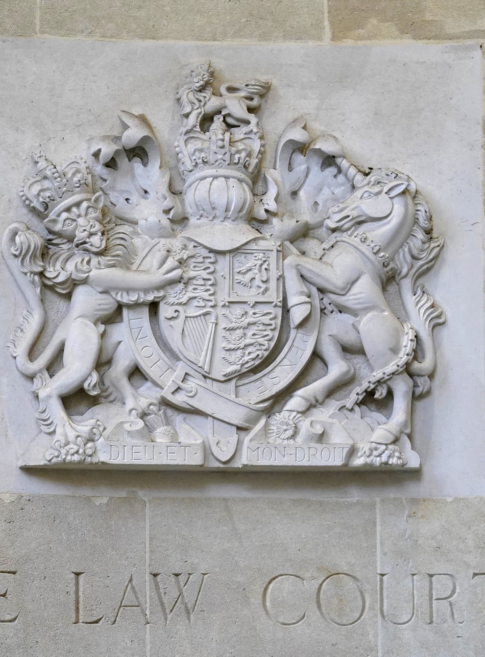 A stone carving of the royal coat of arms above a sign for The Law Courts outside the entrance to Bristol Crown Court (Andrew Matthews/PA)