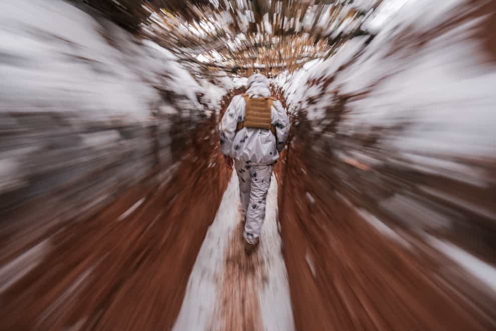 A Ukrainian serviceman walks in a trench at a frontline position in the Donetsk region, eastern Ukraine, on Monday, January 31 2022 (AP Photo/Vadim Ghirda/PA)