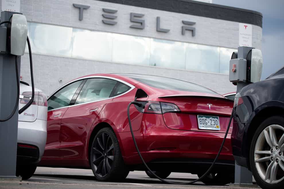 Tesla is recalling nearly 54,000 vehicles because their full self-driving software lets them roll through stop signs without coming to a complete halt (David Zalubowski/AP)