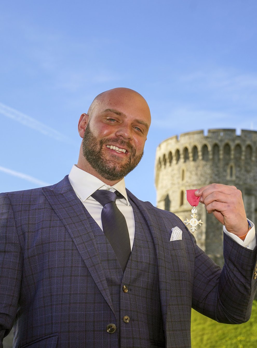 Personal trainer Mike Hind collected his MBE at Windsor Castle after walking 250 miles to get there (Steve Parsons/PA)
