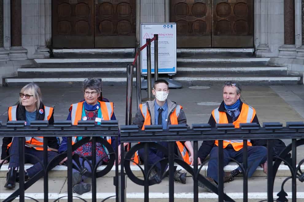 (Left to right) Insulate Britain defendants Theresa Norton, 63, Dr Diana Warner, 62, El Litten, 35 and Steve Pritchard, 62, sitting outside the Royal Courts of Justice in London, as they decided not to return to the afternoon session of their committal hearing (Ian West/PA)