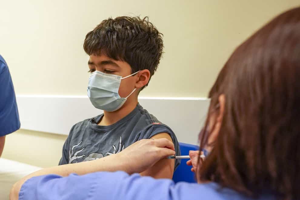 Xavier Aquilina, aged 11, has a Covid-19 vaccination at the Emberbrook Community Centre in Thames Ditton, Surrey (Steve Parsons/PA)