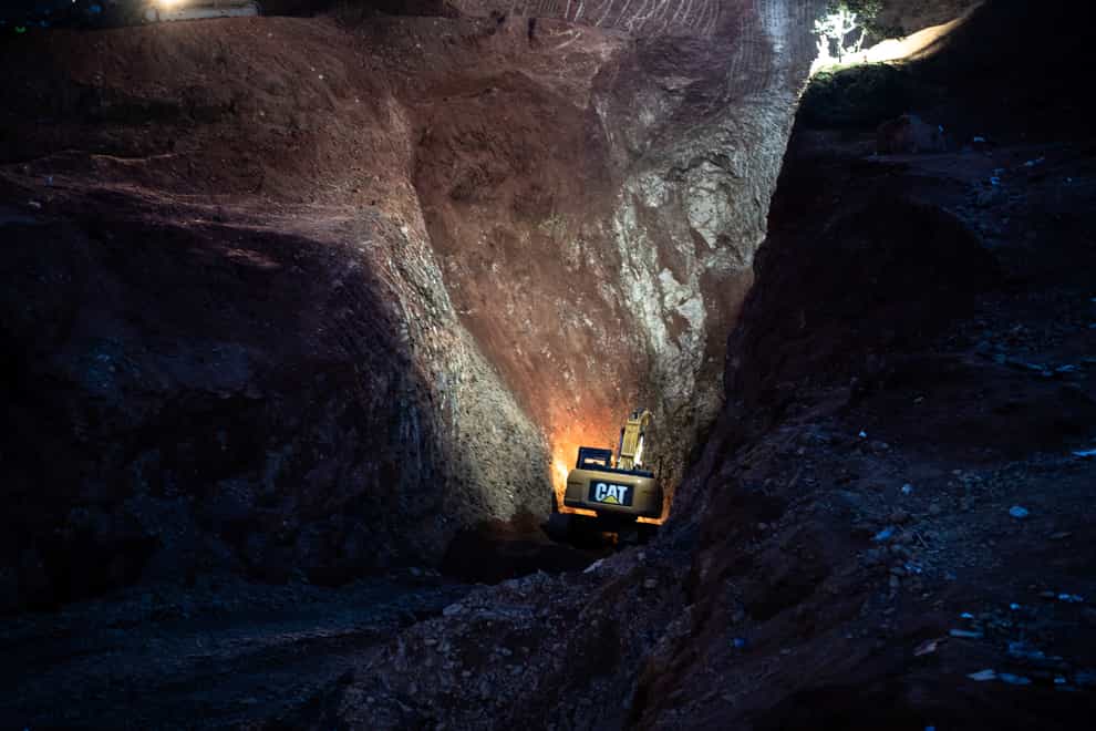 A tractor digs through a mountain during the rescue mission of a boy who fell into a hole in the northern village of Ighran in Morocco’s Chefchaouen province (AP)