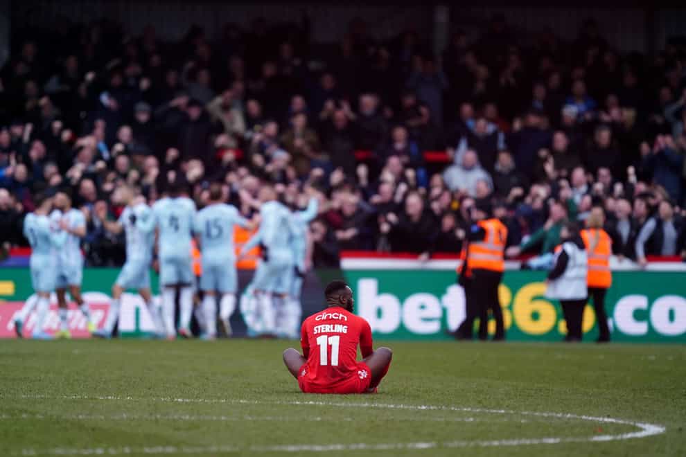 Kidderminster Harriers’ Omari Sterling shows his dejection as West Ham United celebrate their late winning goal during the Emirates FA Cup fourth round match (David Davies/PA)