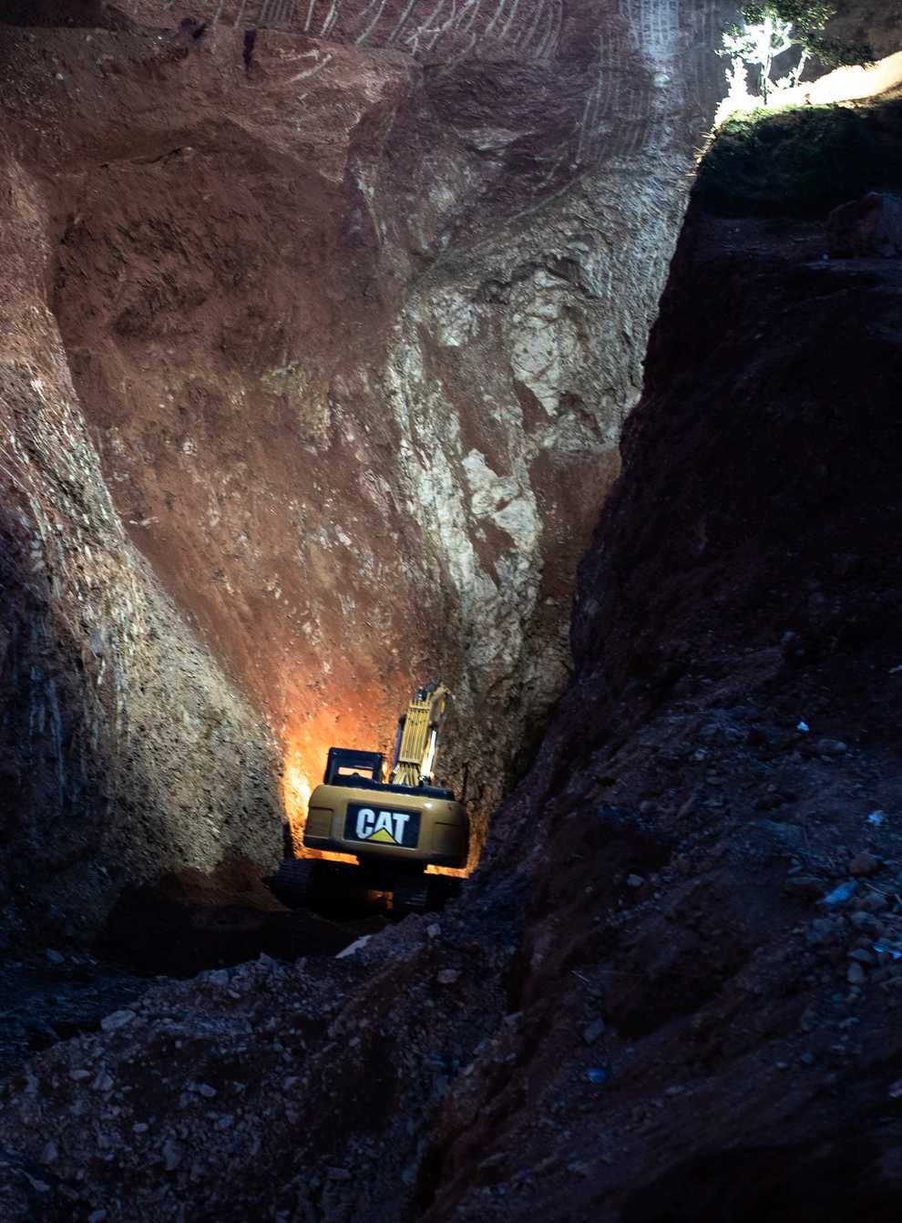 A tractor digs through a mountain during the rescue mission (Mosa’ab Elshamy/AP)