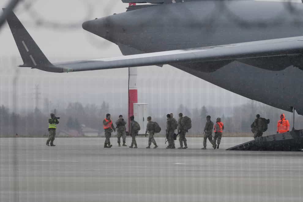 US Army troops of the 82nd Airborne Division unload vehicles from a transport plane (Czarek Sokolowski/AP)