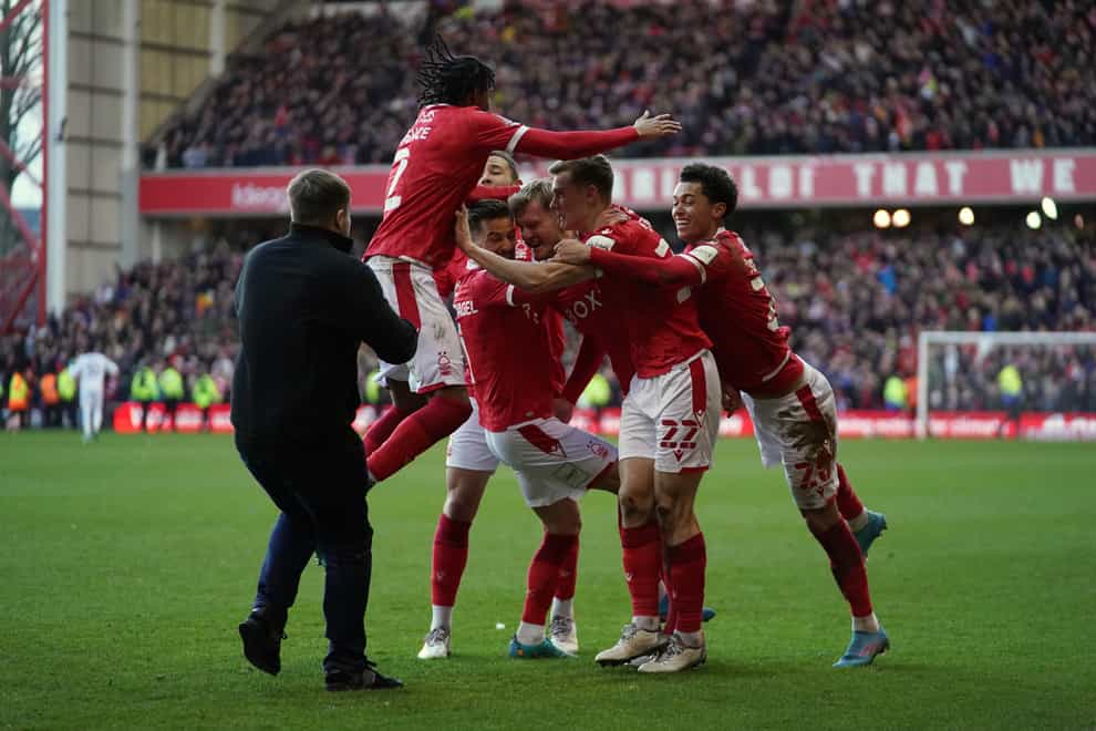 A Leicester City invades the pitch as Nottingham Forest celebrate scoring their side’s third goal of the game (PA)