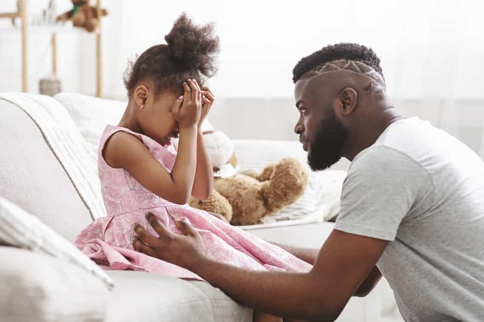 TC2CF4 Loving african american dad comforting crying daughter
