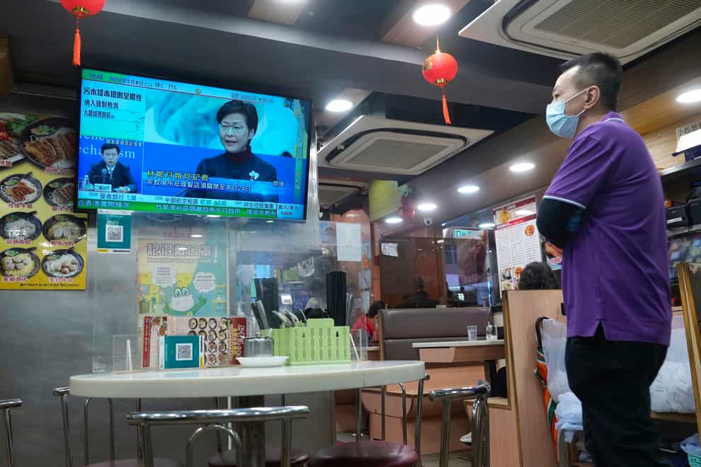A TV screen shows Hong Kong Chief Executive Carrie Lam talking during a news conference (Vincent Yu/AP)