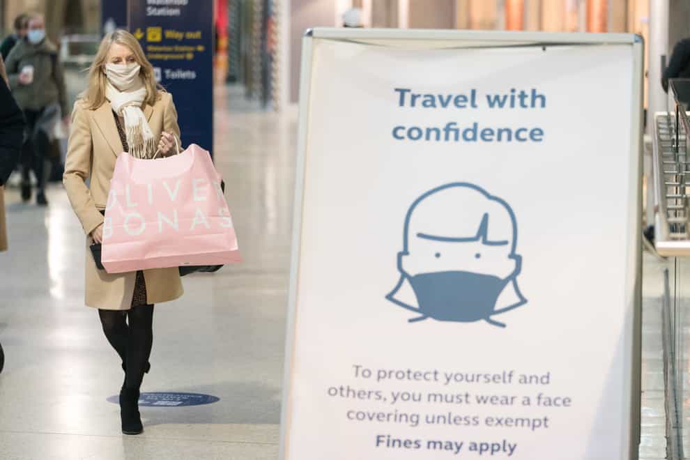 A passenger wearing a face mask at Waterloo railway station in London (Dominic Lipinski/PA)