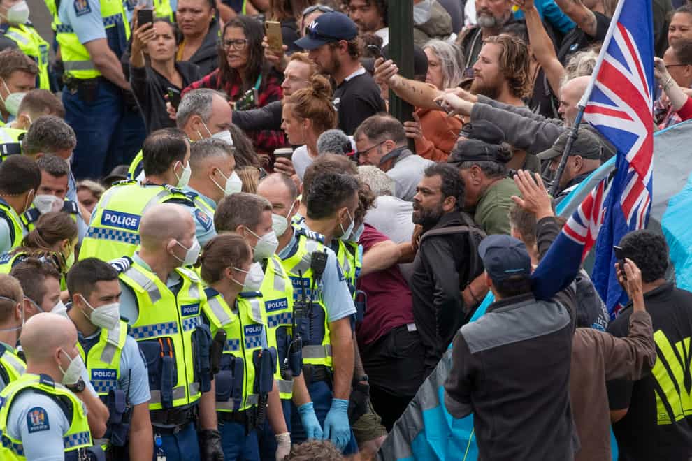 Police arrest people protesting against coronavirus mandates in Wellington, New Zealand (Mark Mitchell/NZ Herald via AP)