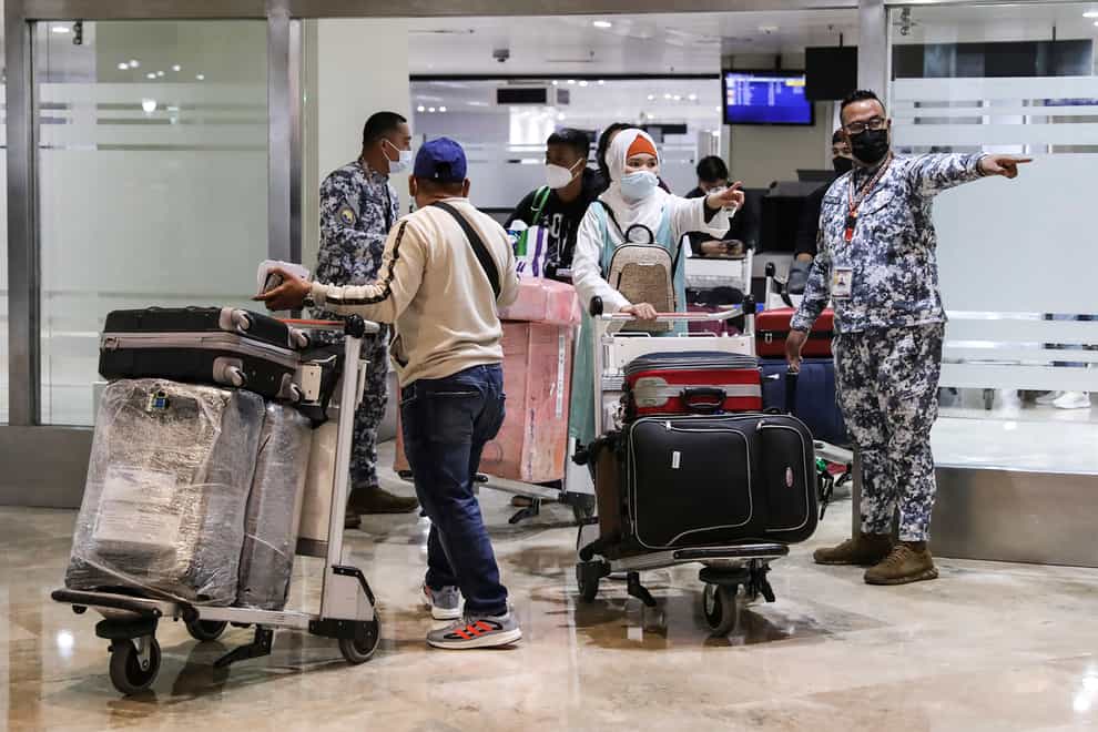 Passengers arrive at Manila’s International Airport (Basilio Sepe/AP)