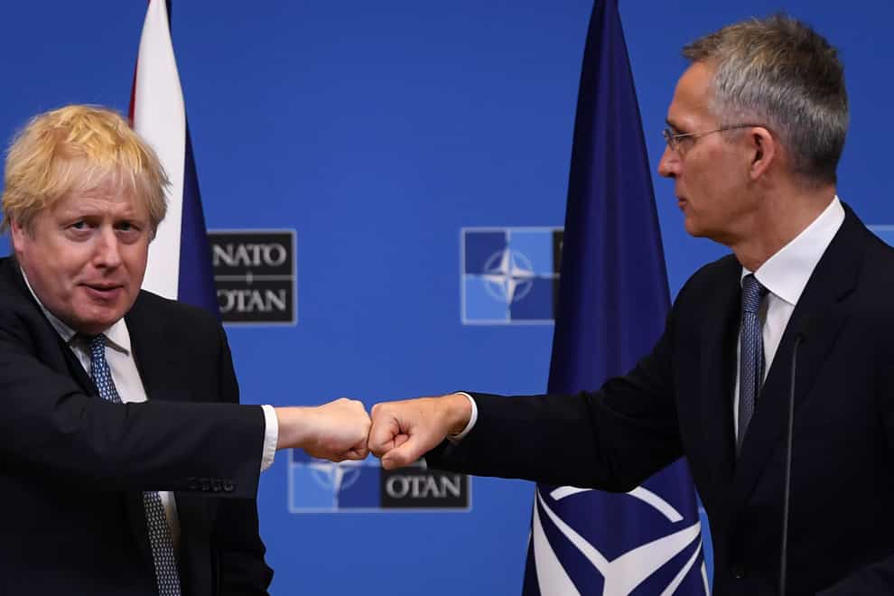 Boris Johnson (left) fist bumps Nato secretary general Jens Stoltenberg in Brussels (Daniel Leal/PA)