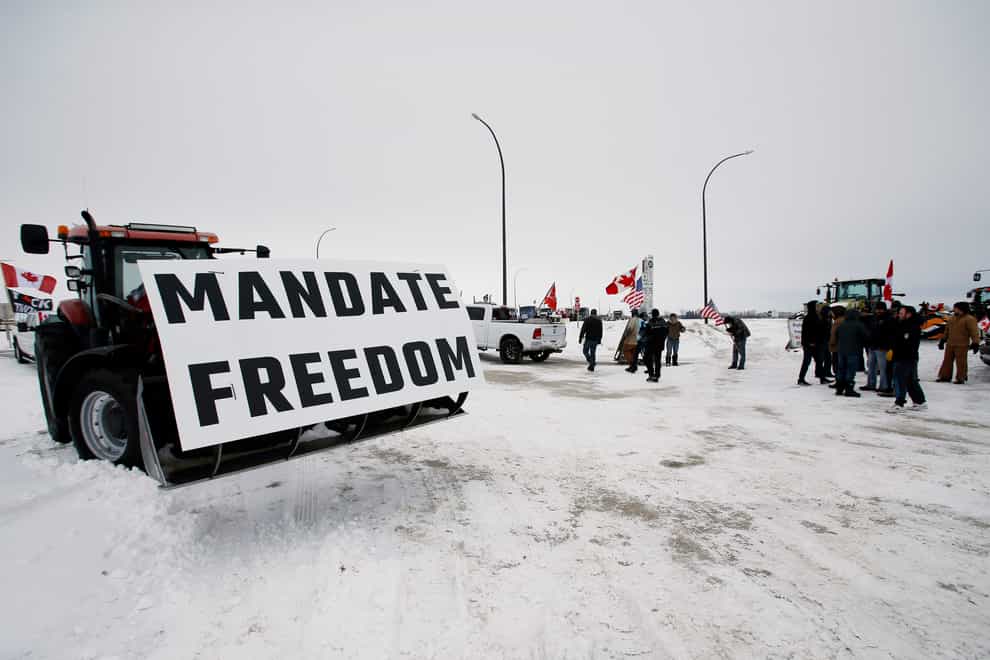 People block highway 75 with heavy trucks and farm equipment and access to the Canada-United States border crossing at Emerson, Manitoba (John Woods/The Canadian Press via AP)