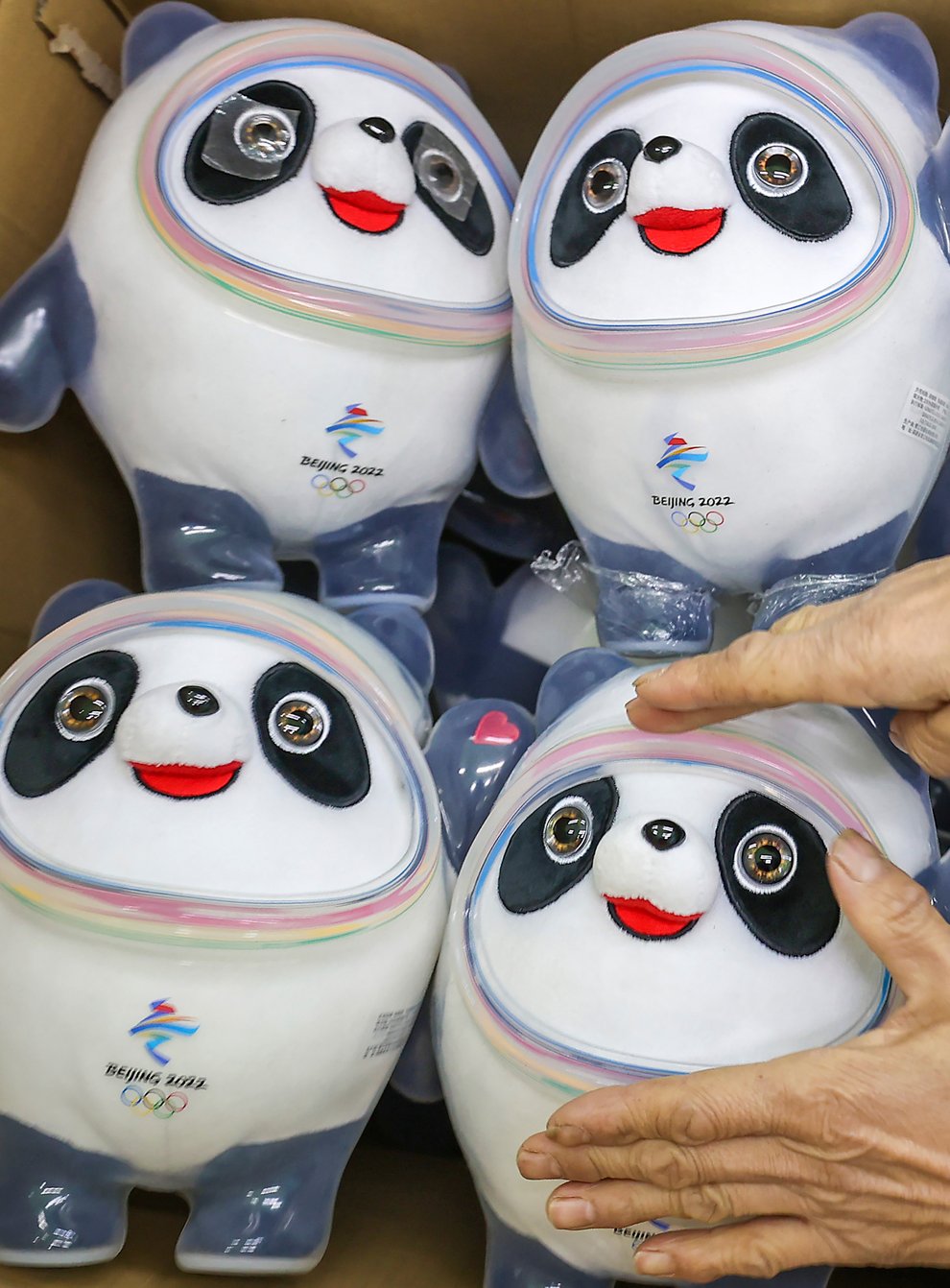 A worker packs away completed Bing Dwen Dwen stuffed dolls, the mascot of 2022 Winter Olympics, in Jinjiang city in southeastern China’s Fujian province (Chinatopix via AP)