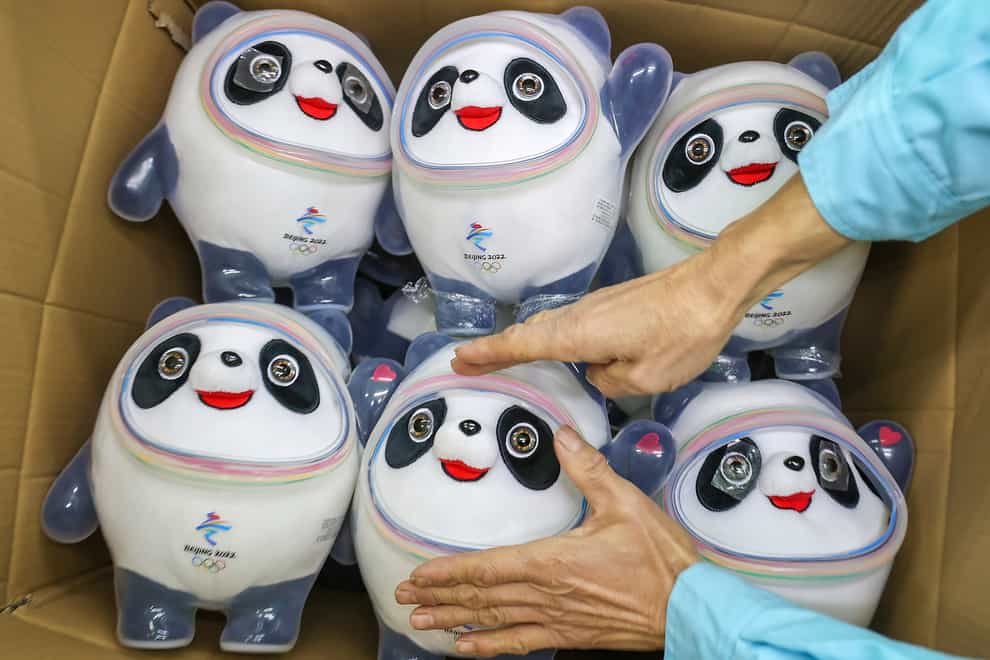 A worker packs away completed Bing Dwen Dwen stuffed dolls, the mascot of 2022 Winter Olympics, in Jinjiang city in southeastern China’s Fujian province (Chinatopix via AP)